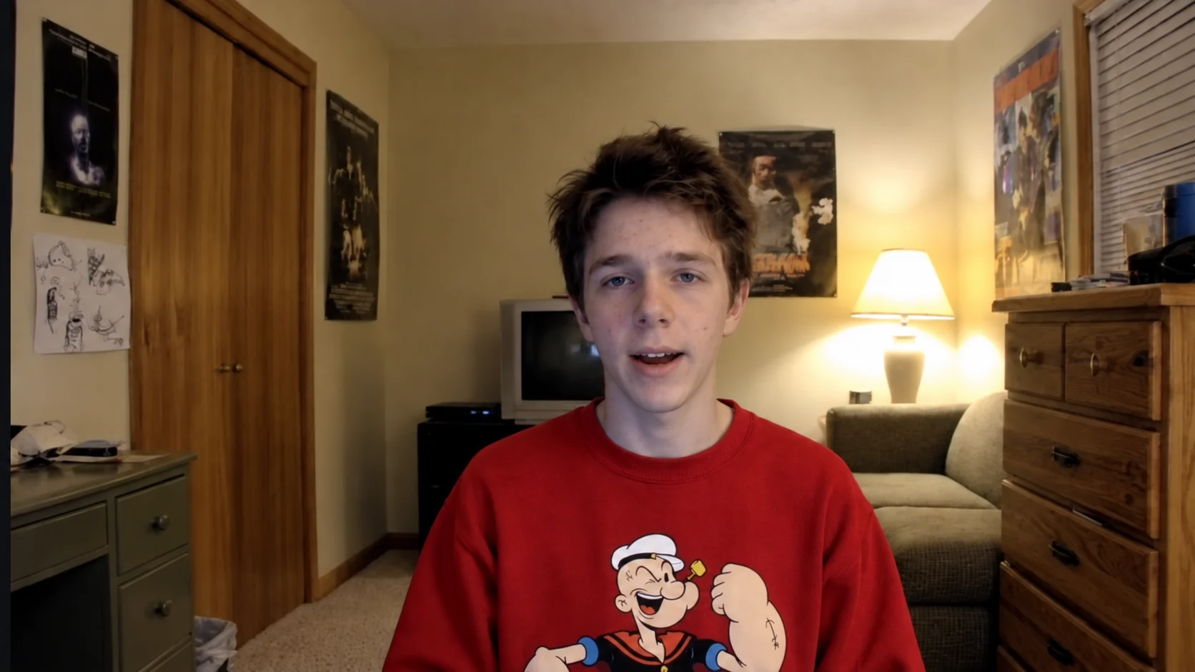 Toby in his red sweatshirt in a warmly lit room